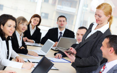 Businesswoman giving an explanation to colleagues. ???????????????????????????????????????????????????????